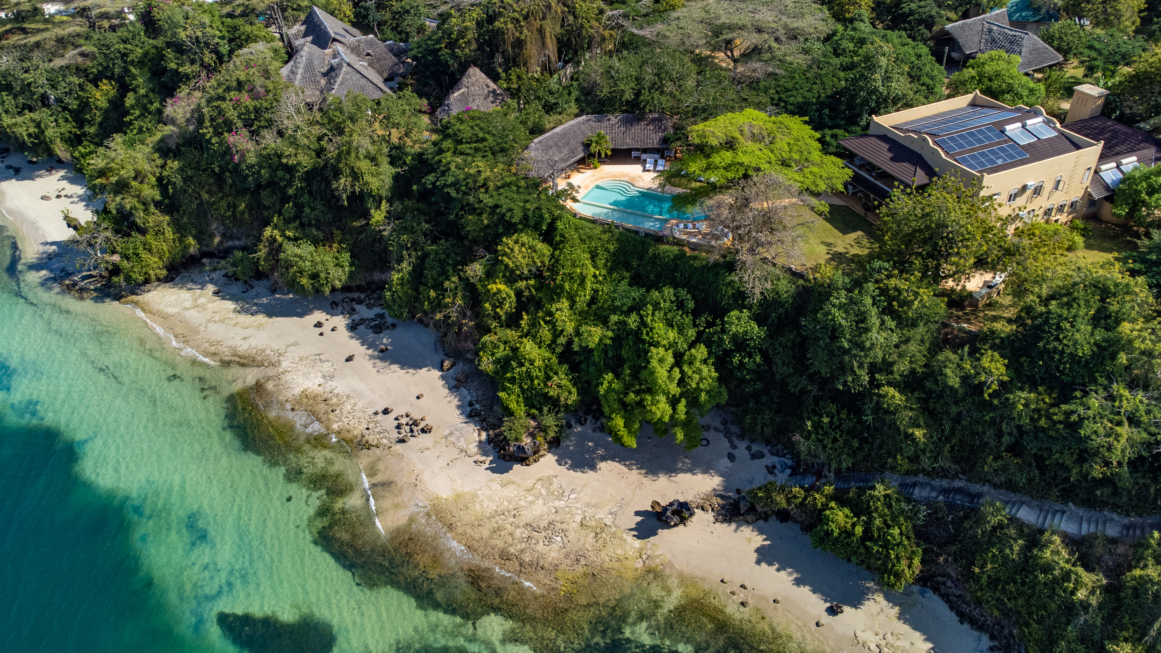 Aerial view of Mwangati House and its pool above the beach